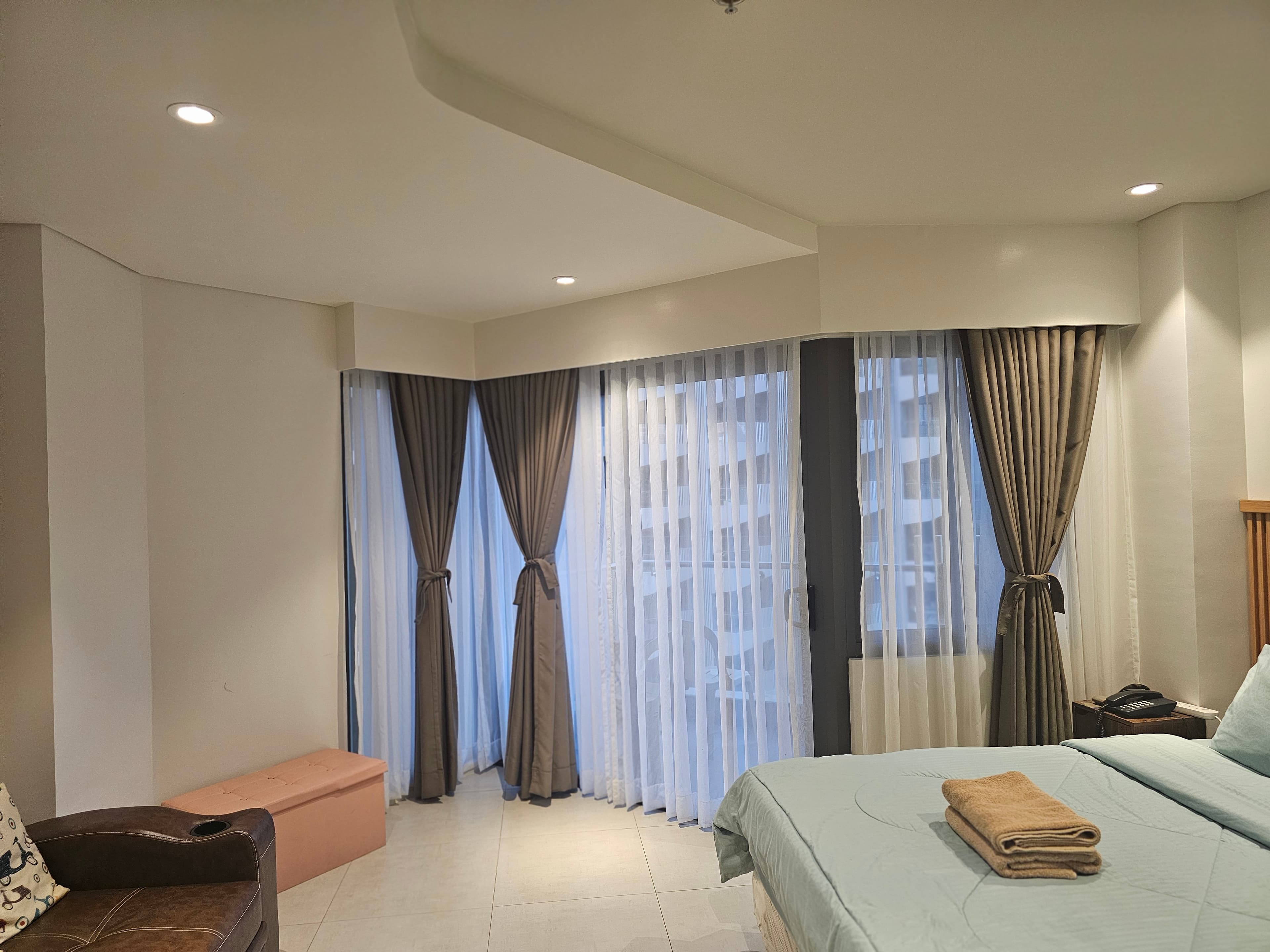 Studio living space with floor-to-ceiling curtains